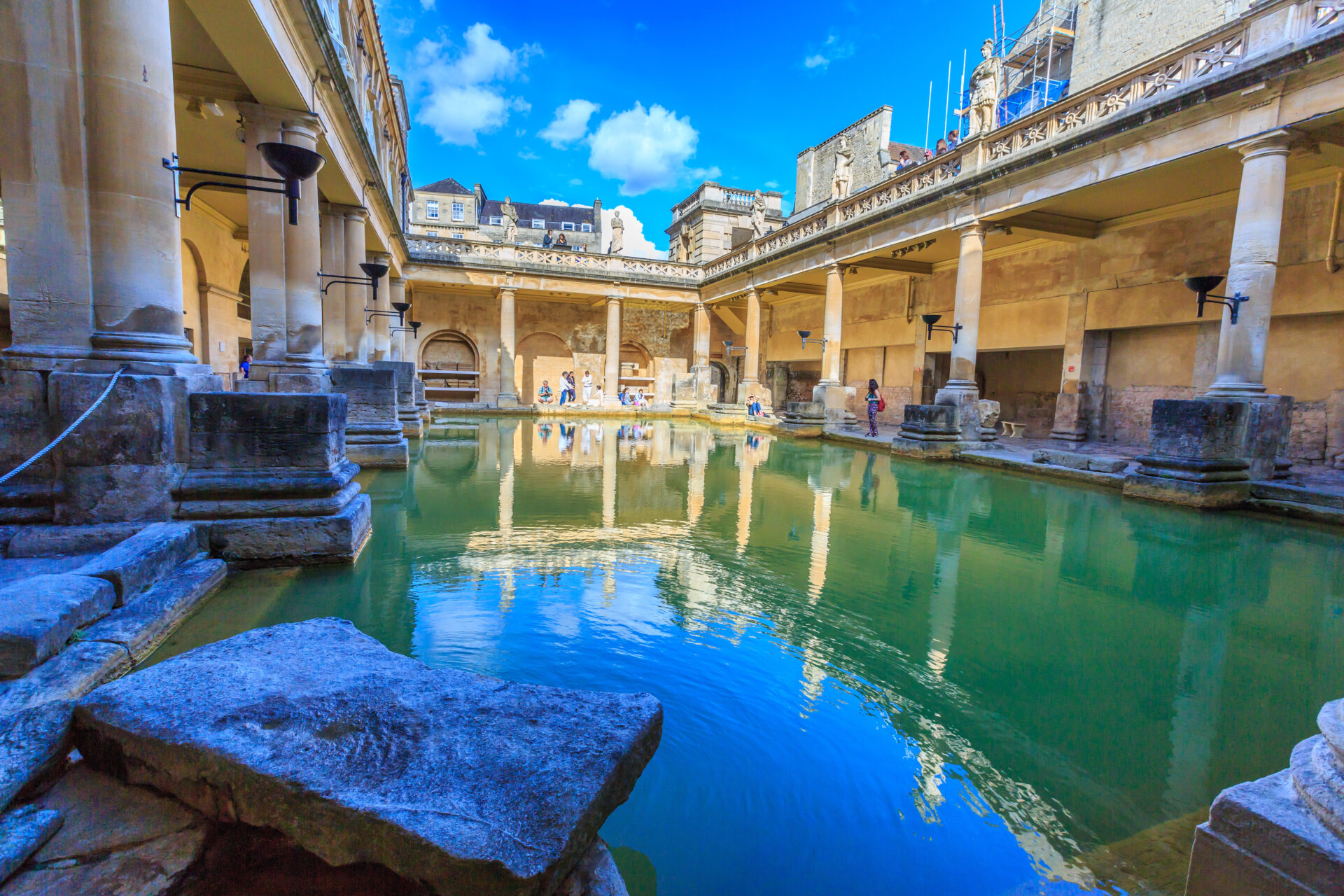 inside of Roman Baths with unidentified people, which is a site of historical interest in the city of Bath. The house is a well-preserved Roman site for public bathing